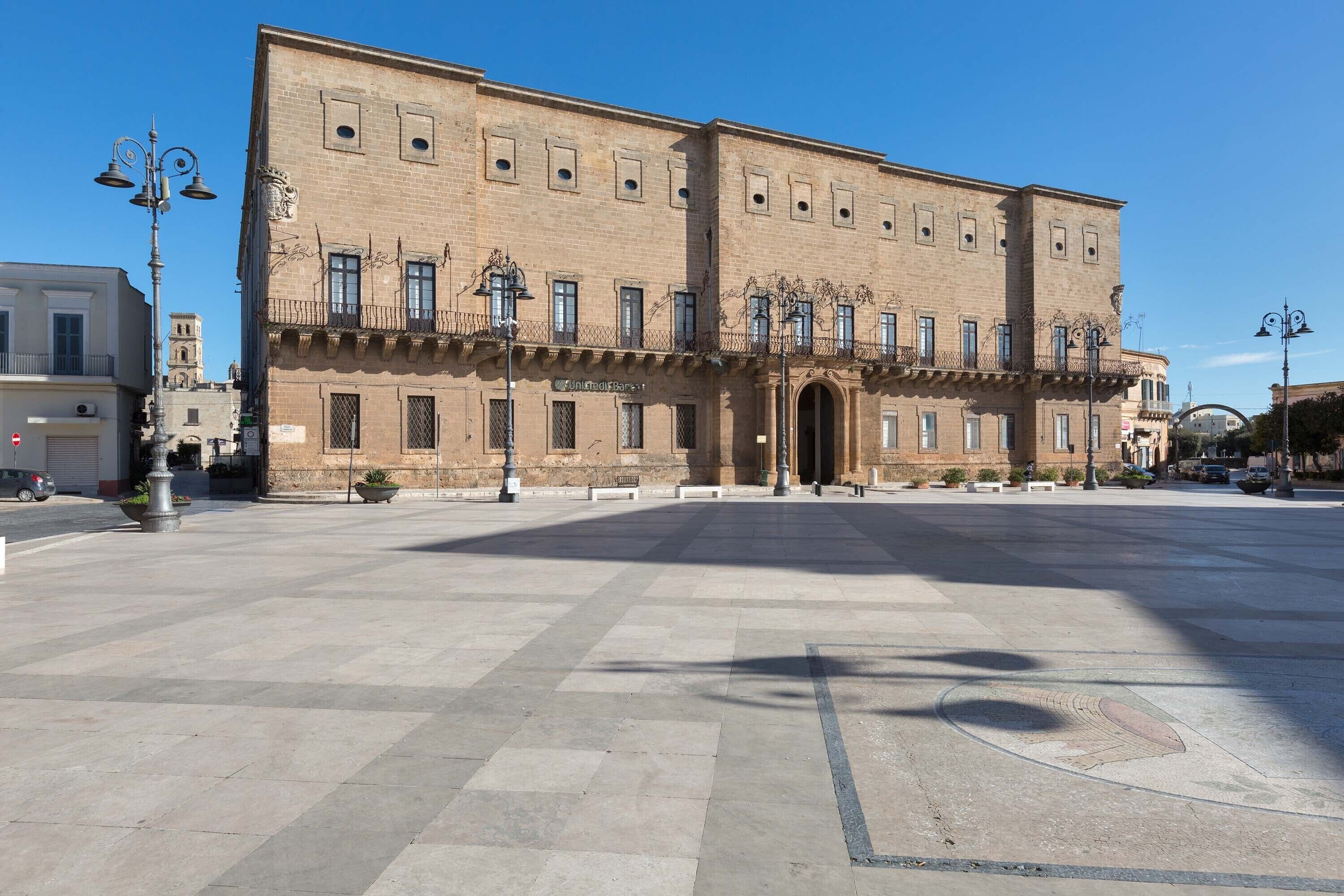 A large, historic building with a symmetrical facade, multiple windows, and a central entrance.