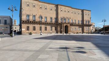 A large, historic building with a symmetrical facade, multiple windows, and a central entrance.