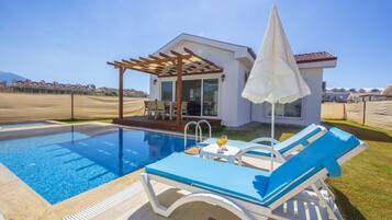 Seasonal outdoor pool, pool umbrellas, pool loungers