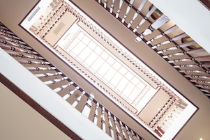 A grand staircase with a high ceiling and a central open space.