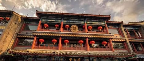 A traditional building with multiple balconies, ornate decorations, and a prominent entrance.