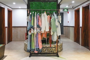 A clothing rack with various garments in a hotel lobby.