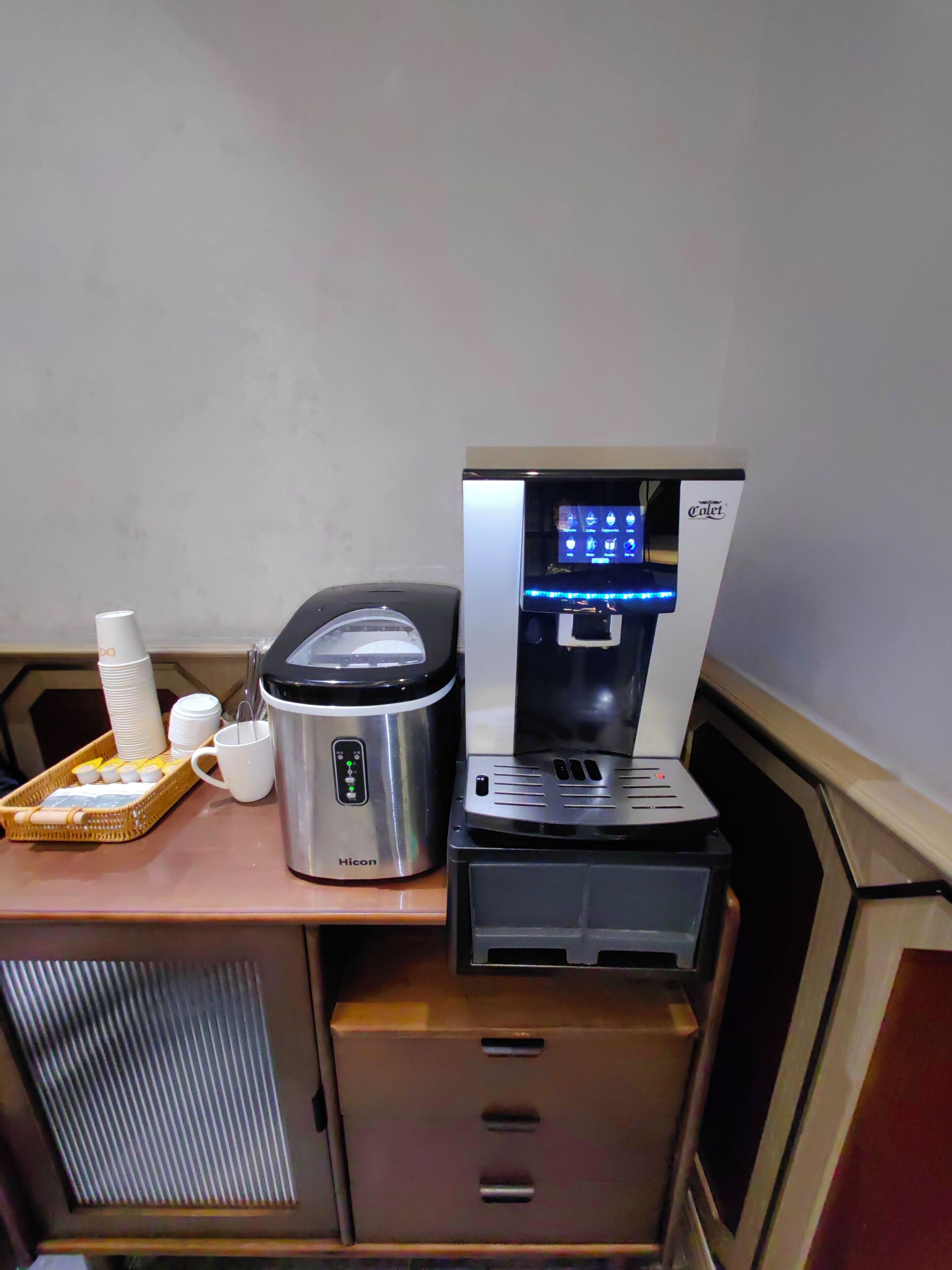 A kitchenette with a coffee maker, a water dispenser, and a microwave.
