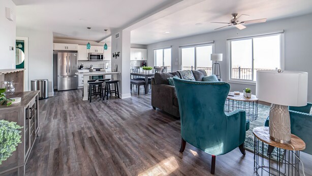 A spacious living area with a modern kitchen, a dining table, and a comfortable seating area. - Quaint house on the bluffs overlooking the  scenic Missouri River. (Atchison)
