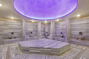 A luxurious room with a large bed, marble walls, and a ceiling with a circular light fixture. - Wyndham Baku (Baku)