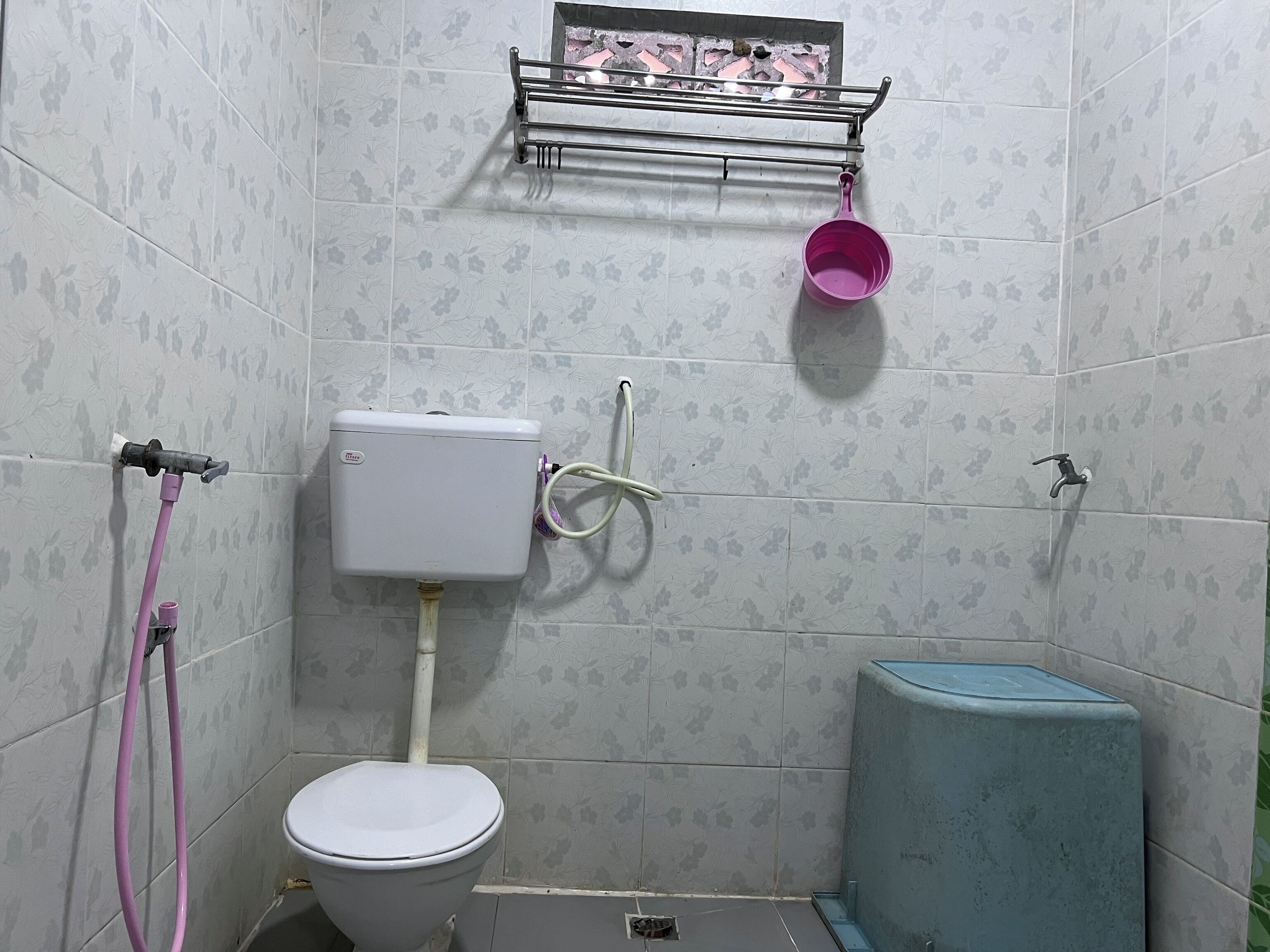 A small bathroom with a toilet, a sink, and a shower area.