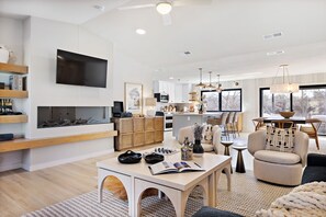 TV connectée, cheminée, livres, chaîne hi-fi