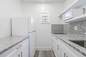 Fridge, microwave, stovetop, coffee/tea maker