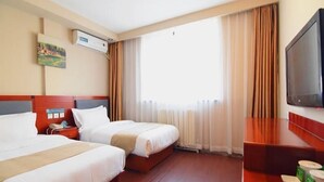 A hotel room with two beds, a flat-screen TV, a painting on the wall, and a large window with curtains. - Greentree Inn Beijing Chaoyang District Happy Valley Express Hotel (Beijing)