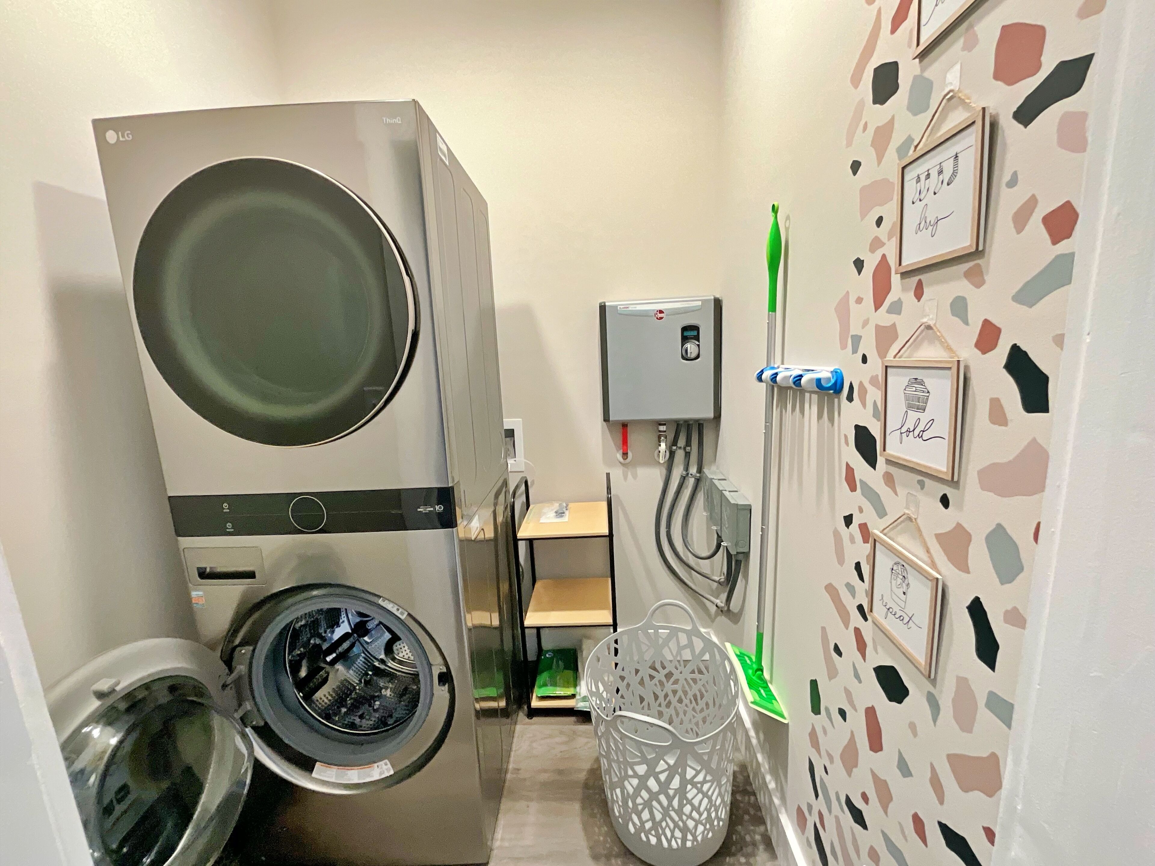 A compact laundry room with a front-loading washing machine, a dryer, and a water heater.