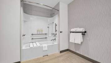 A modern bathroom with a glass-enclosed shower, a bathtub, and a towel rack.