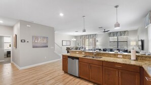 A spacious kitchen with granite countertops, wooden cabinets, and a dishwasher. - 5 Star Villa With 9 Bedrooms, Orlando Villa 4227 (Davenport)