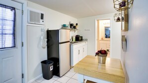 A compact kitchen with a refrigerator, microwave, and a small countertop. - Lakeland Vacation Rental: 38 Mi to Disney! (Lakeland)