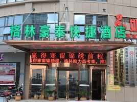 A hotel with a prominent signboard displaying its name and services.