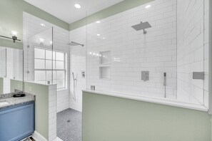 Bathtub, hair dryer, towels, toilet paper
