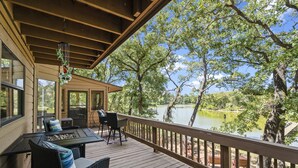 A wooden deck with outdoor seating, overlooking a lake. - Beautiful, relaxing & Peaceful (Huntsville)