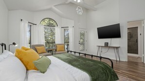 A modern bedroom with a large bed, a desk, a chair, and a TV. - Beautiful, relaxing & Peaceful (Huntsville)
