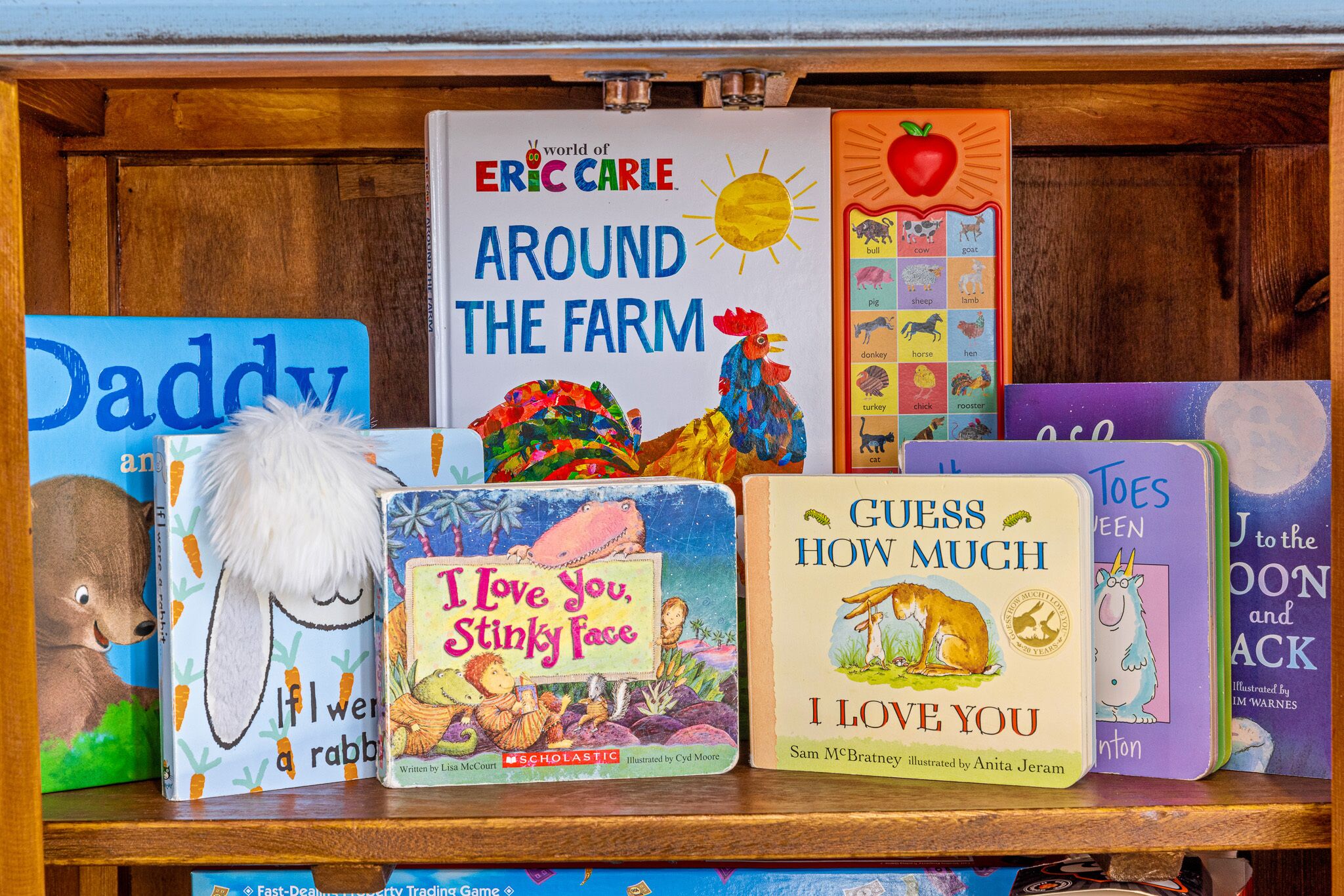 A bookshelf with children's books, including titles like "Around the Farm" and "I Love You, Stinky Face".