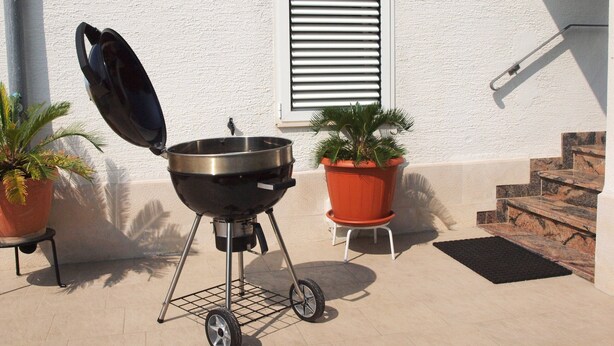 An outdoor grill with wheels, a potted plant, and a window with shutters. - Ana Guest House - Double room with private terrace (Nin)