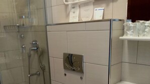 A bathroom with a glass-enclosed shower, a white toilet, and a sink with a mirror. - Ana Guest House - Double room with private terrace (Nin)