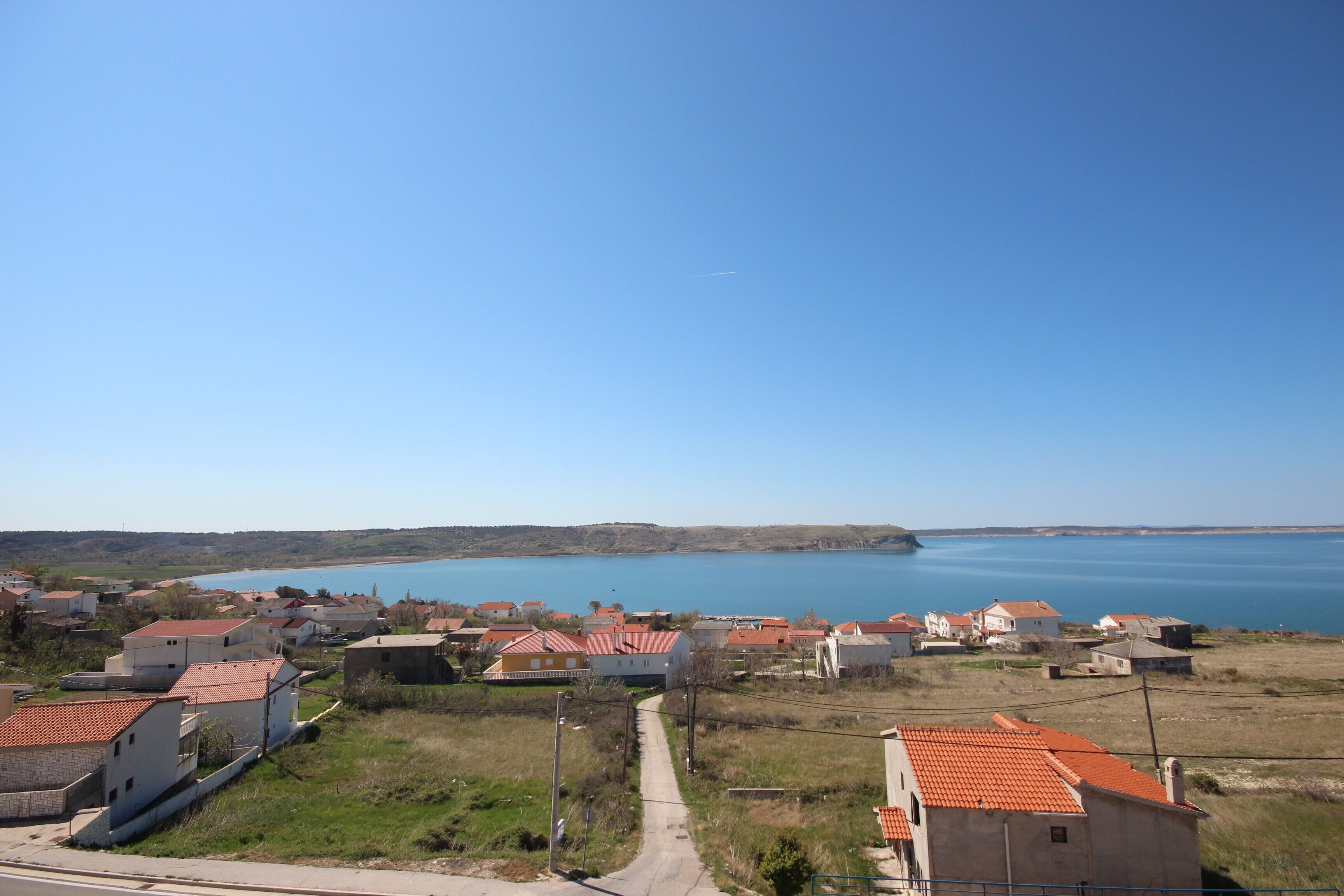 A coastal village with houses and a clear view of the sea.