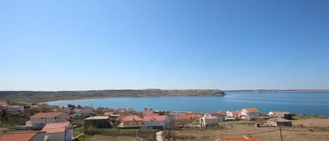 A coastal village with houses and a clear view of the sea.