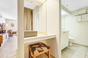 A bathroom with a toilet, sink, and towel rack.