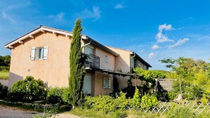 A two-story house with a balcony, surrounded by greenery and a clear blue sky. - Chez Georges - House 3 - Lakes and Gorges du Verdon (ESPARRON DE VERDON)