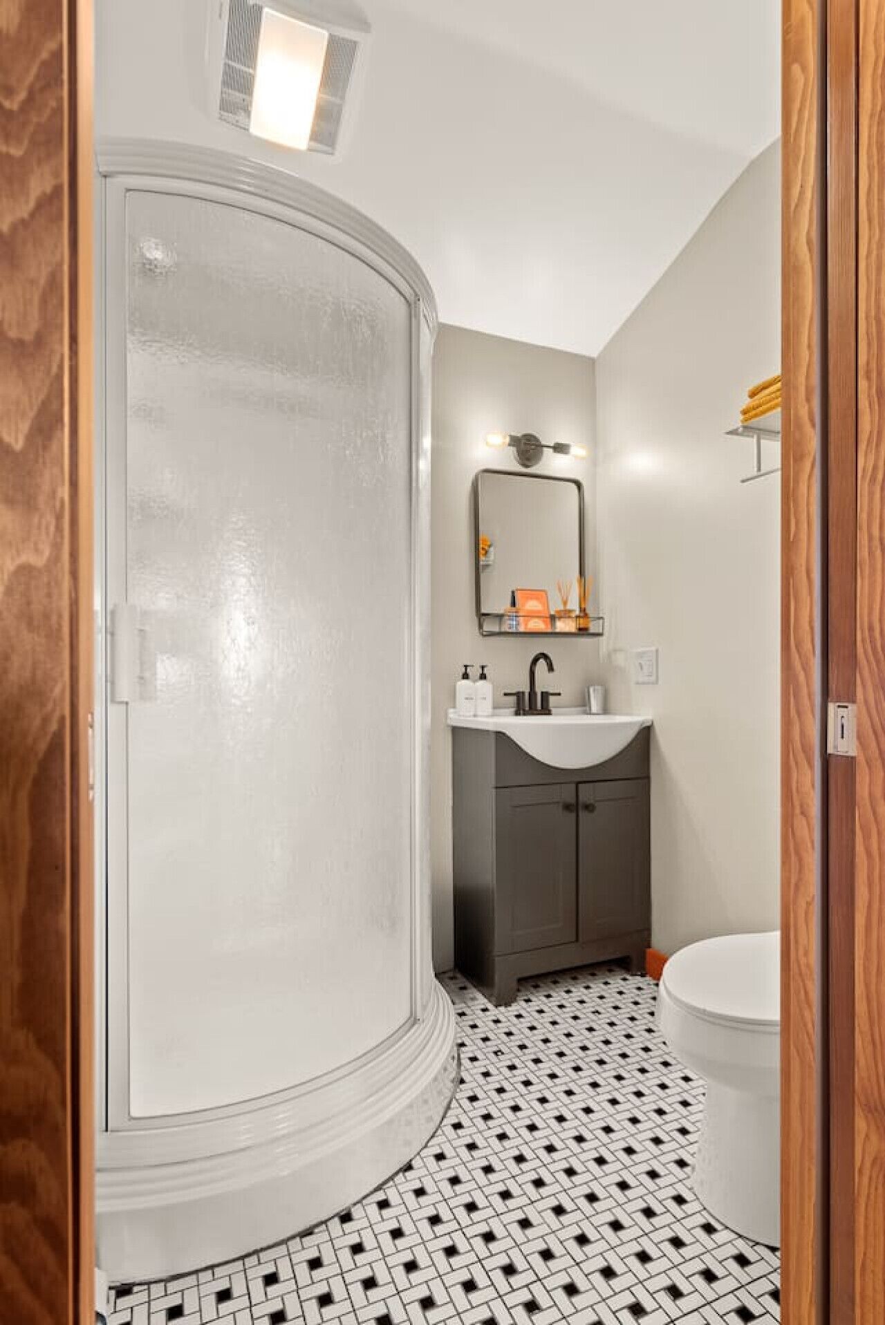 A bathroom with a shower, sink, and toilet.