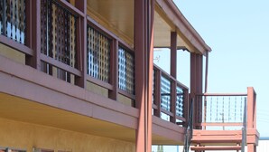A multi-story building with a central staircase, large windows, and a flat roof. - Cinderella Motel (Wasco)