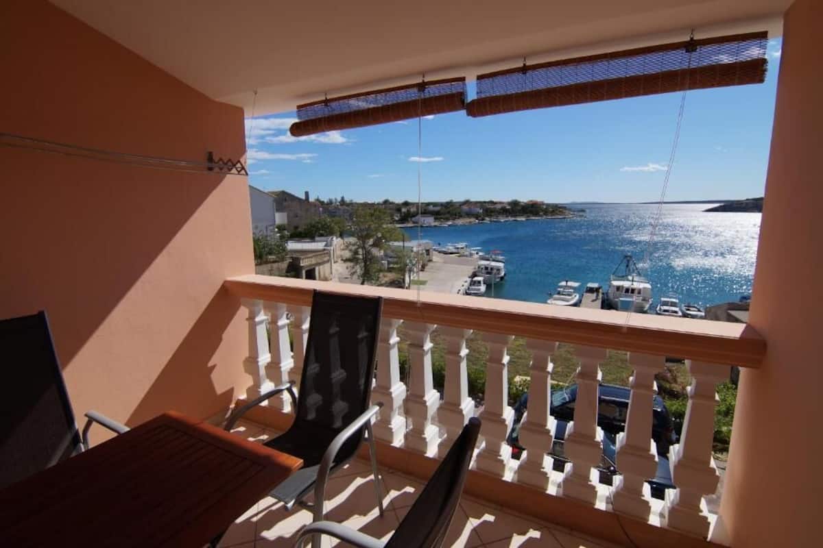 A balcony with a view of a marina and boats.