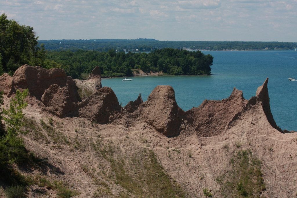 A rugged landscape with rocky outcrops and a body of water in the background.