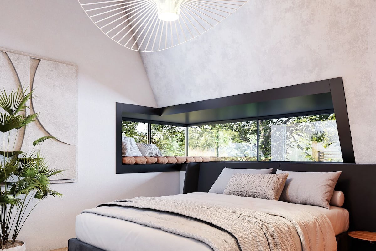 A modern bedroom with a bed, a large window, a hanging light fixture, and a potted plant.