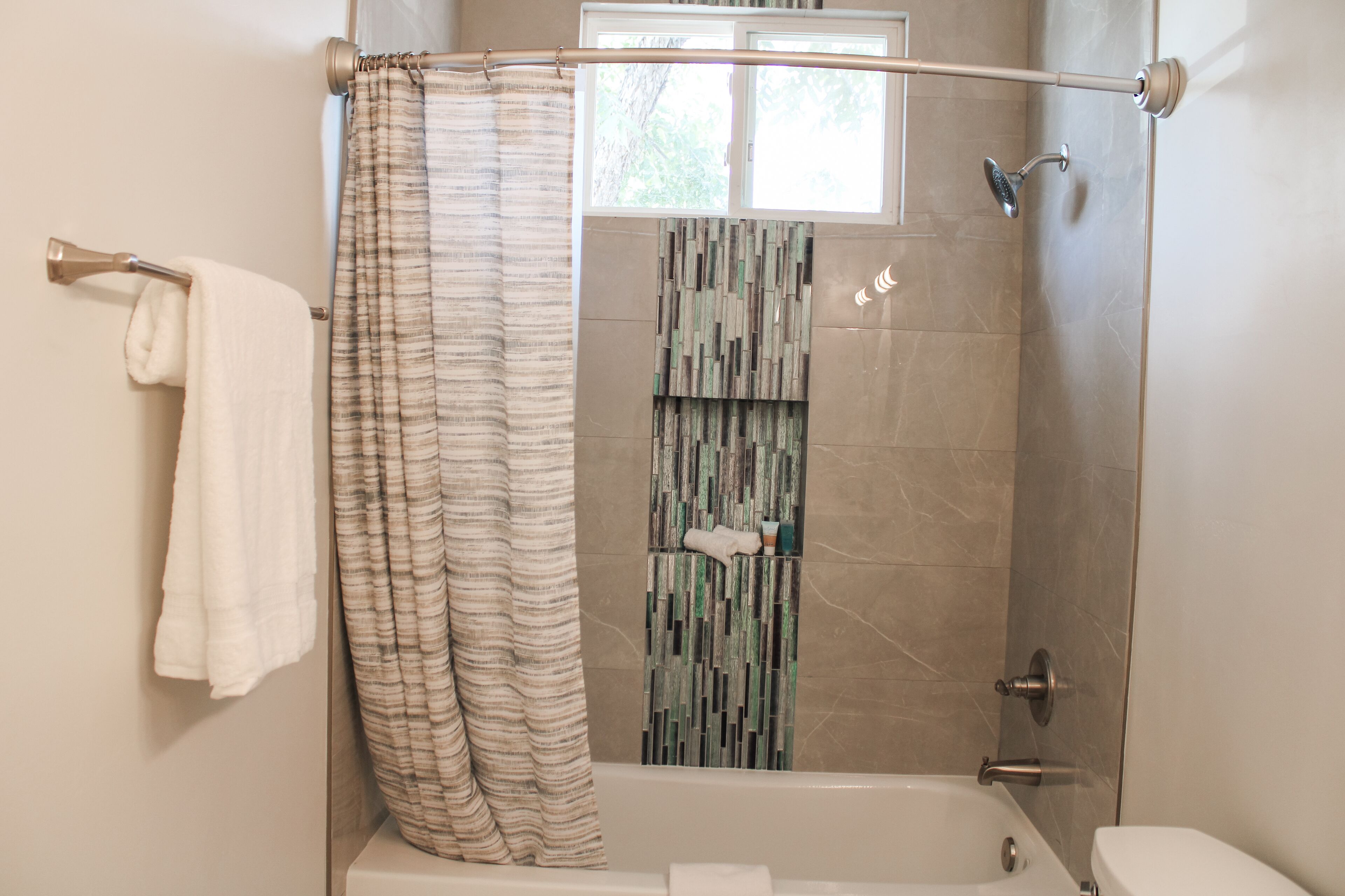 Un baño con ducha, bañera y retrete.
