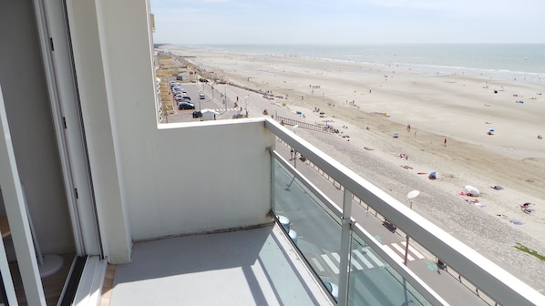 A balcony with a view of a beach.