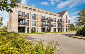 A multi-story residential building with balconies, large windows, and a modern architectural design. - Awesome apartment in Nordstrand with WiFi (Nordstrand)