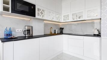 Microwave, dishwasher, coffee/tea maker, cookware/dishes/utensils