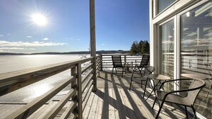 A wooden deck with a view of a body of water, a glass door, and outdoor furniture. - Awesome home in åmotfors with WiFi (Åmotfors)