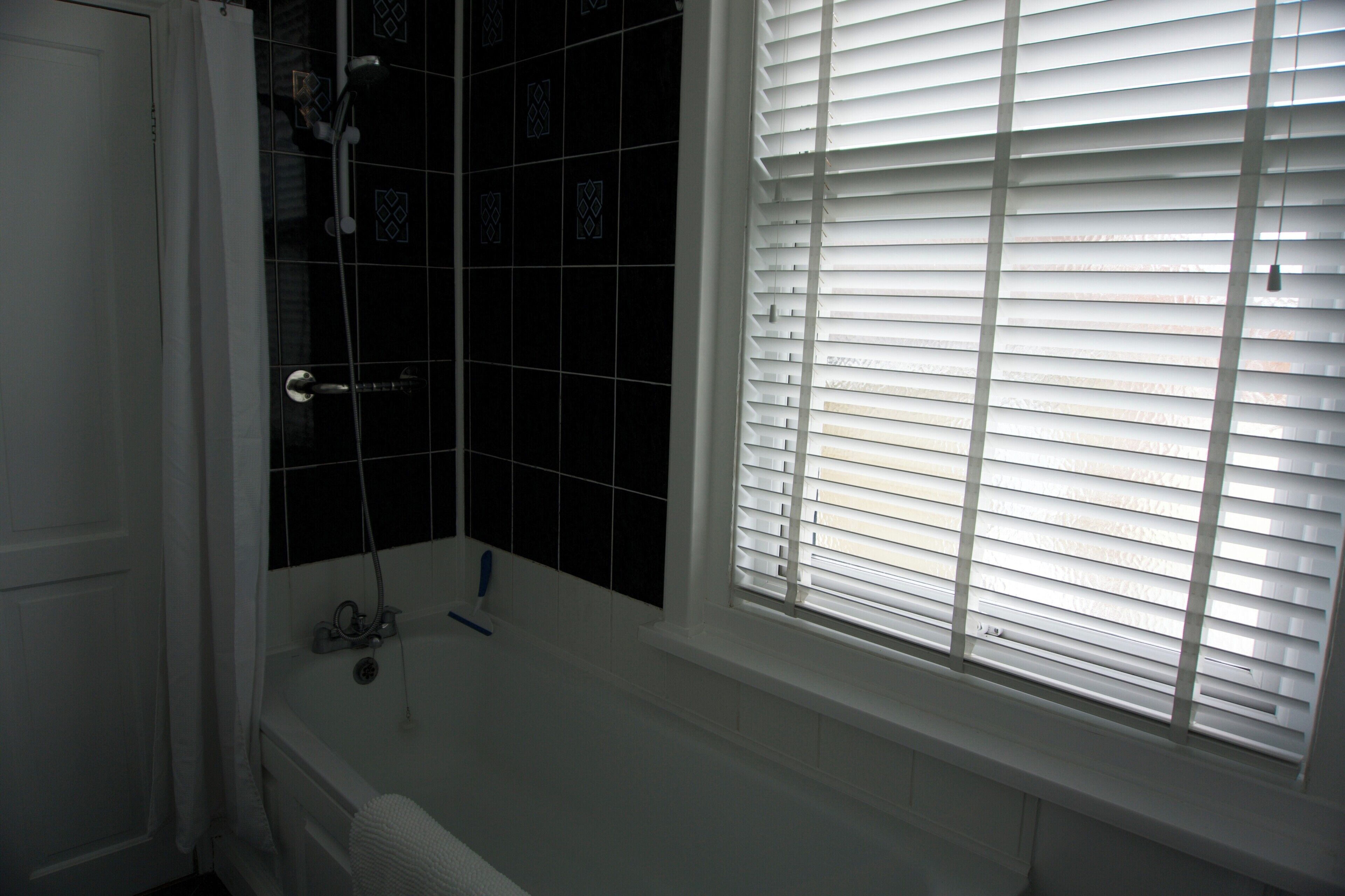 Combined shower/bathtub, deep-soaking bathtub, hair dryer, towels