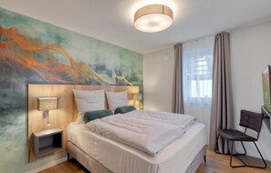 Relax in a stylish space with a large bed, bedside tables, and a seating area.