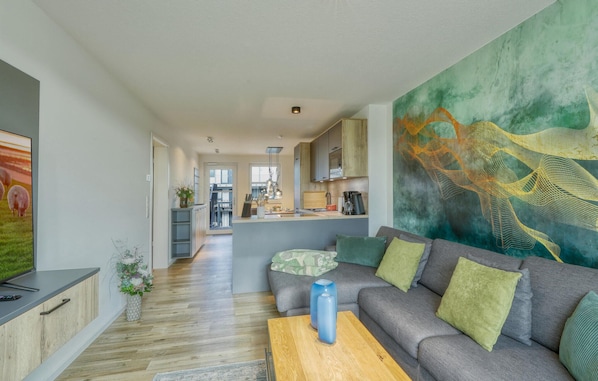Relax in this stylish living space with a sofa, coffee table, and large abstract art piece.