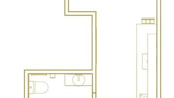 A floor plan of a hotel room with a bathroom, a kitchenette, and a seating area.