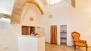 A compact kitchen with a built-in oven, a sink, and a clock on the wall. - 3180 Appartamento Raffaella by Barbarhouse (Gallipoli)