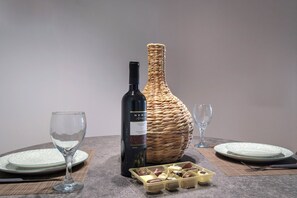Enjoy a romantic dinner for two with wine, a sweet treat, and a beautifully set table.