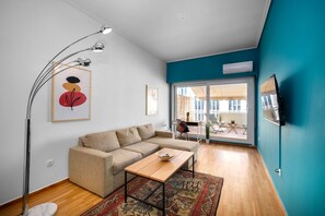 Relax in this stylish living room with a comfortable sofa, coffee table, and large window offering a view of the outside.