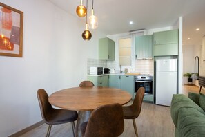 Enjoy meals around the round dining table, surrounded by comfortable chairs.