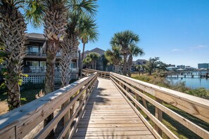 Walk along the beachfront boardwalk, flanked by palm trees, to reach this oceanfront property with stunning views.