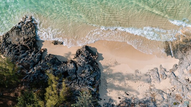 A beach with clear turquoise water, rocky formations, and sandy areas. - BRAND NEW & Waterfront 2bedroom 2bath ~ Lanai (Current)