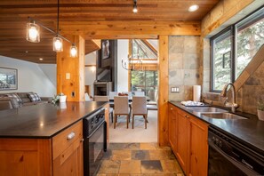 Enjoy meals in the kitchen with a central island, large window, and dining area.