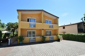 Enjoy a home away from home with a balcony offering views of the surrounding courtyard and lush potted plants.